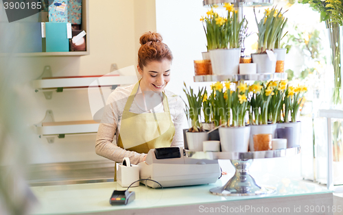 Image of florist woman at flower shop cashbox on counter