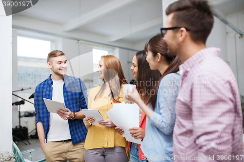 Image of creative team on coffee break talking at office