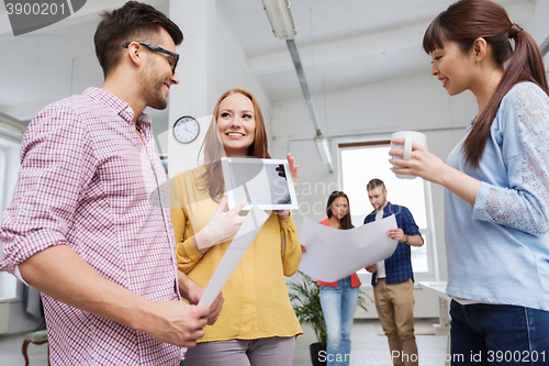 Image of creative team with tablet pc talking at office