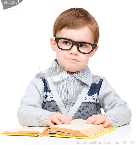 Image of Little child play with book