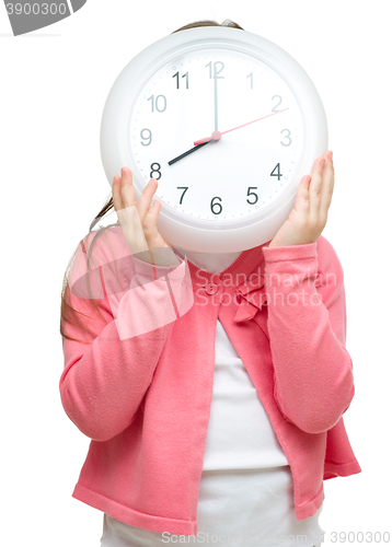 Image of Little girl is holding big clock