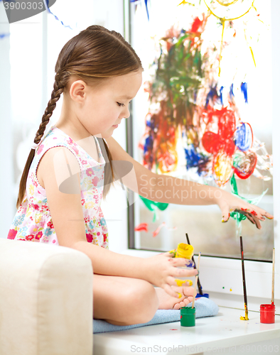 Image of Portrait of a cute girl playing with paints