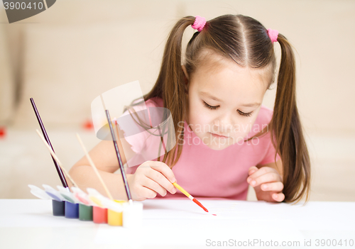 Image of Cute cheerful child play with paints
