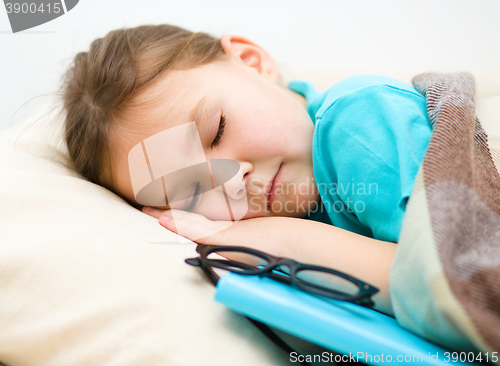 Image of Girl is sleeping with her book and glasses
