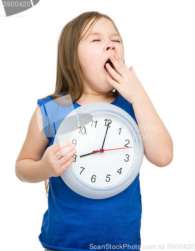 Image of Little girl is holding big clock