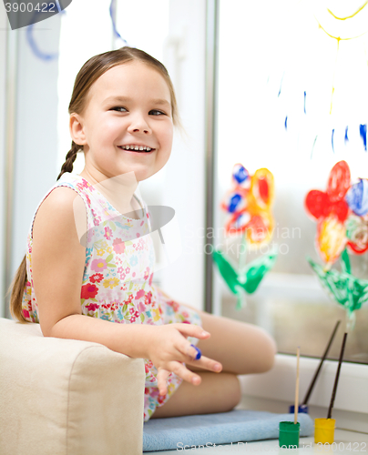 Image of Portrait of a cute girl playing with paints