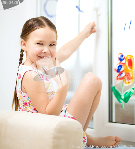 Image of Portrait of a cute girl playing with paints