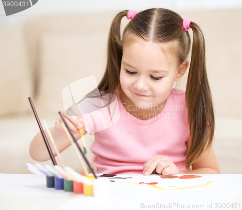 Image of Cute cheerful child play with paints