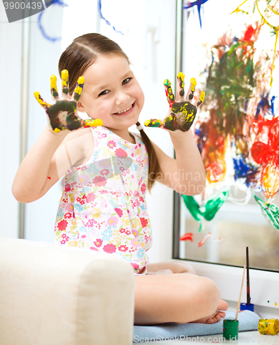 Image of Portrait of a cute girl playing with paints