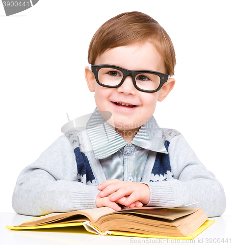 Image of Little child play with book