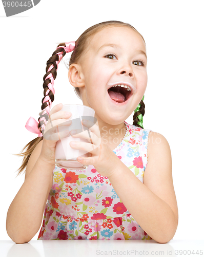 Image of Cute little girl with a glass of milk