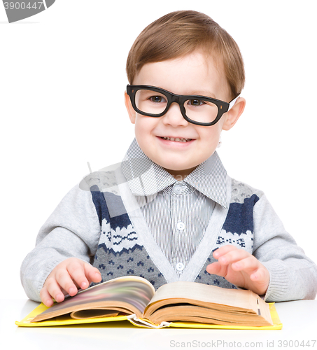 Image of Little child play with book