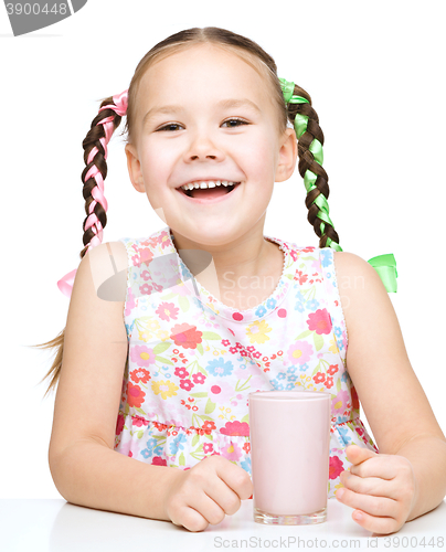 Image of Cute little girl with a glass of milk