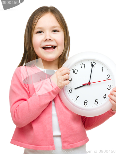 Image of Little girl is holding big clock