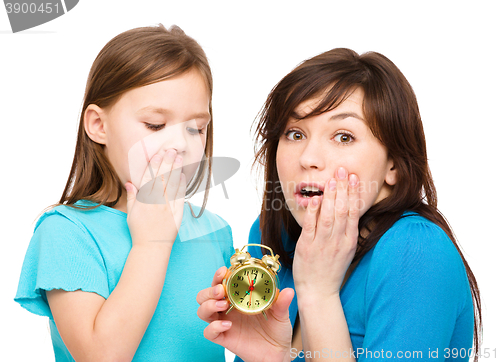 Image of Little girl and her mother are anxious about time