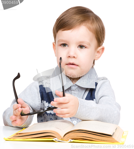 Image of Little child play with book