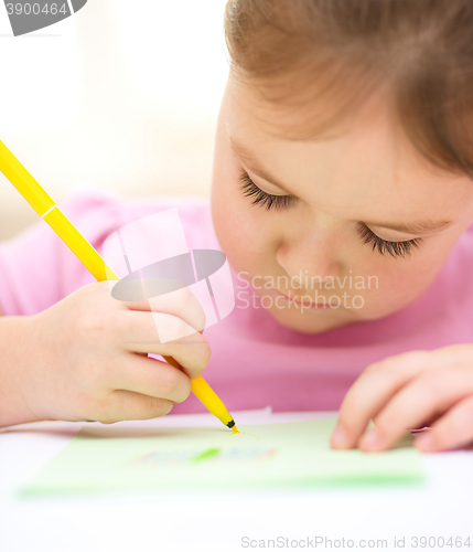 Image of Cute cheerful child drawing using felt-tip pen