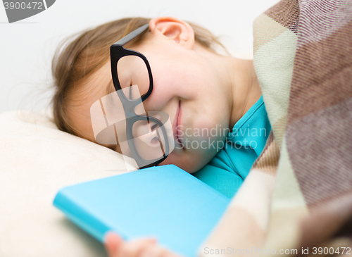 Image of Girl is sleeping with her book and glasses