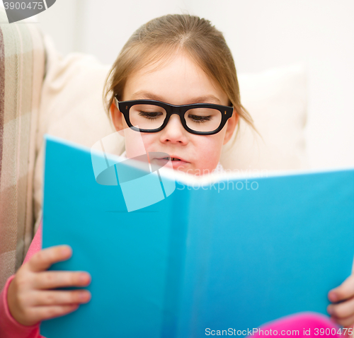 Image of Little girl is reading a book