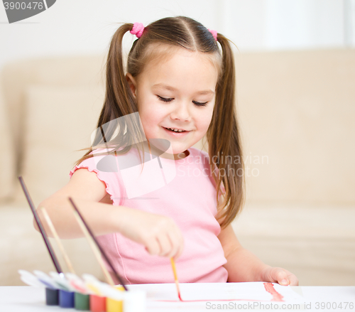 Image of Cute cheerful child play with paints