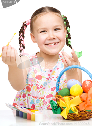 Image of Little girl preparing eggs for Easter