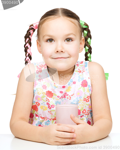 Image of Cute little girl with a glass of milk