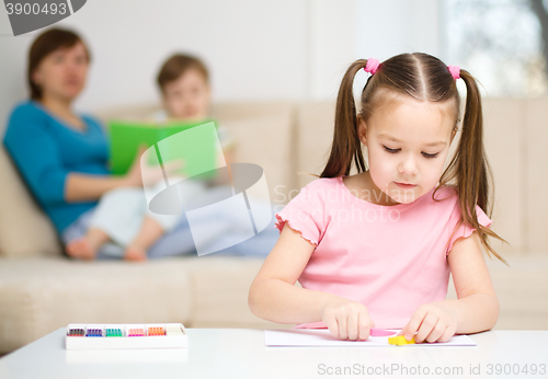 Image of Little girl is playing with plasticine