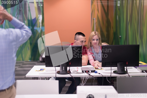 Image of teacher and students in computer lab classroom