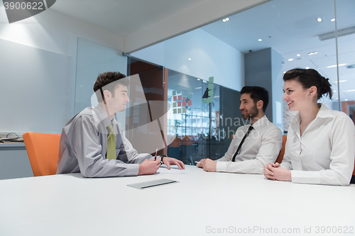 Image of young couple signing contract documents on partners back