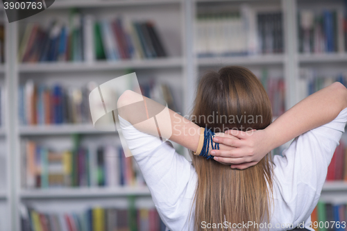 Image of female student study in library, using tablet and searching for 