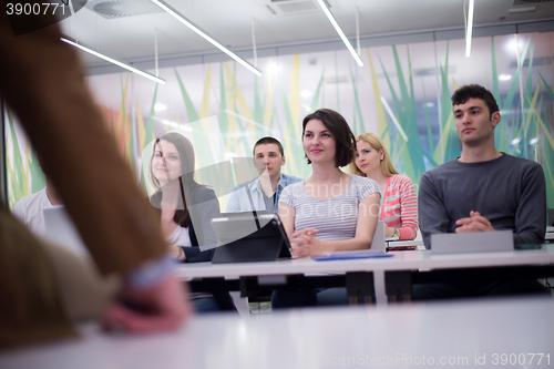 Image of teacher with a group of students in classroom