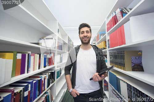 Image of student with tablet in library