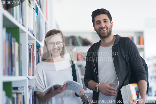 Image of students couple  in school  library