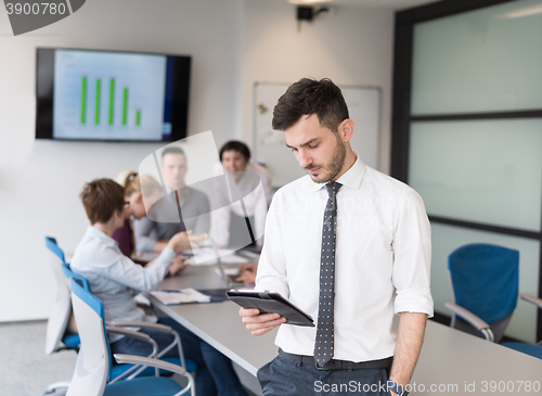Image of young business man with tablet at office meeting room