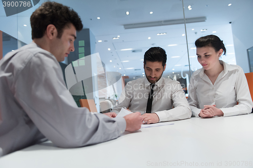 Image of young couple signing contract documents on partners back