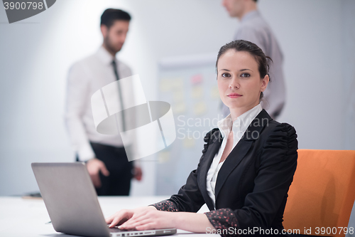 Image of young business woman on meeting  using laptop computer