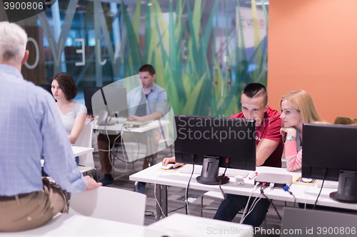 Image of teacher and students in computer lab classroom