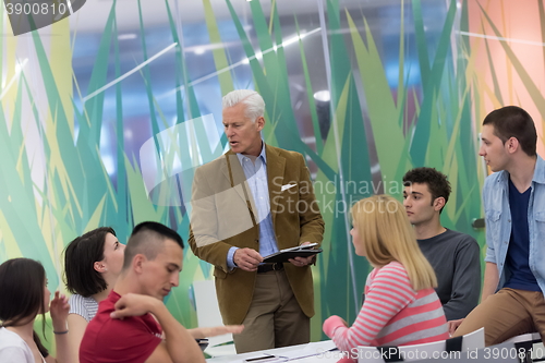 Image of teacher with a group of students in classroom