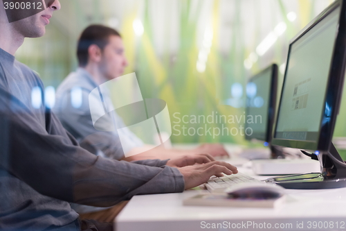 Image of technology students group working  in computer lab school  class