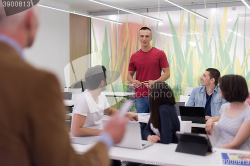 Image of teacher with a group of students in classroom