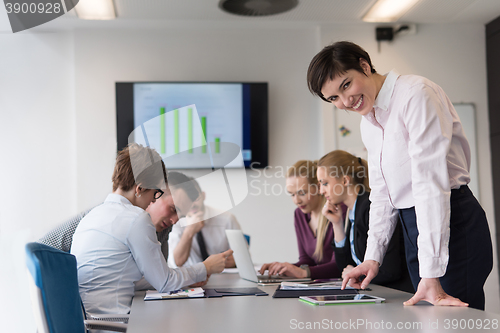 Image of young  woman using  tablet on business meeting