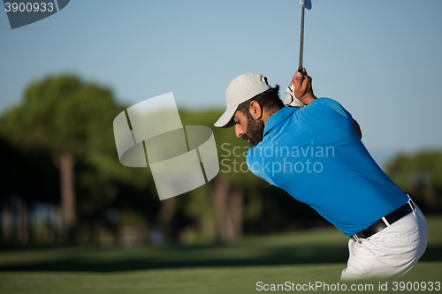 Image of pro golfer hitting a sand bunker shot