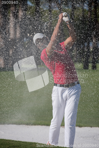 Image of golfer hitting a sand bunker shot