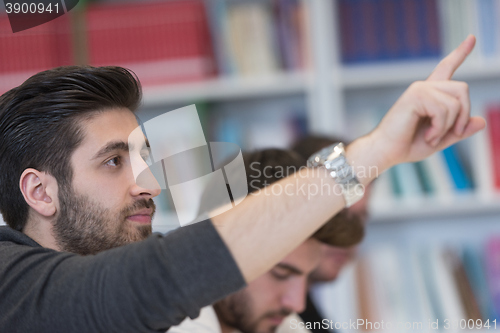 Image of group of students  raise hands up