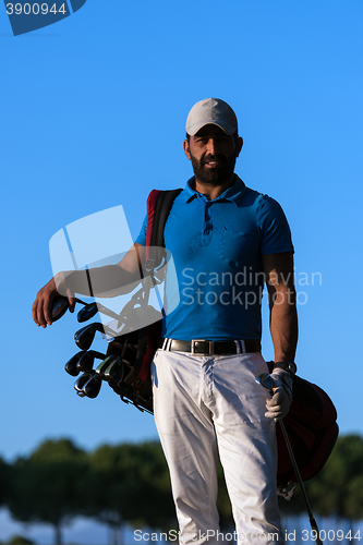 Image of golfer  portrait at golf course on sunset