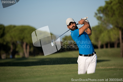 Image of pro golfer hitting a sand bunker shot