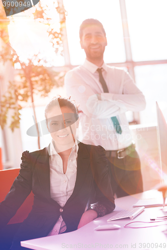 Image of business couple working together on project, sunrise in backgrou