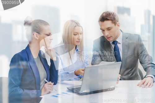 Image of business team with laptop having discussion