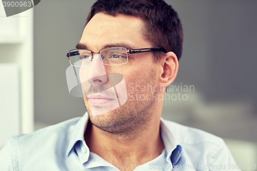 Image of portrait of businessman in eyeglasses at office