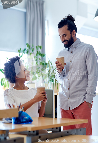 Image of happy man and woman drinking coffee in office